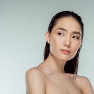 beautiful asian young woman, isolated on grey